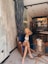 woman in black tank top sitting on brown wooden chair