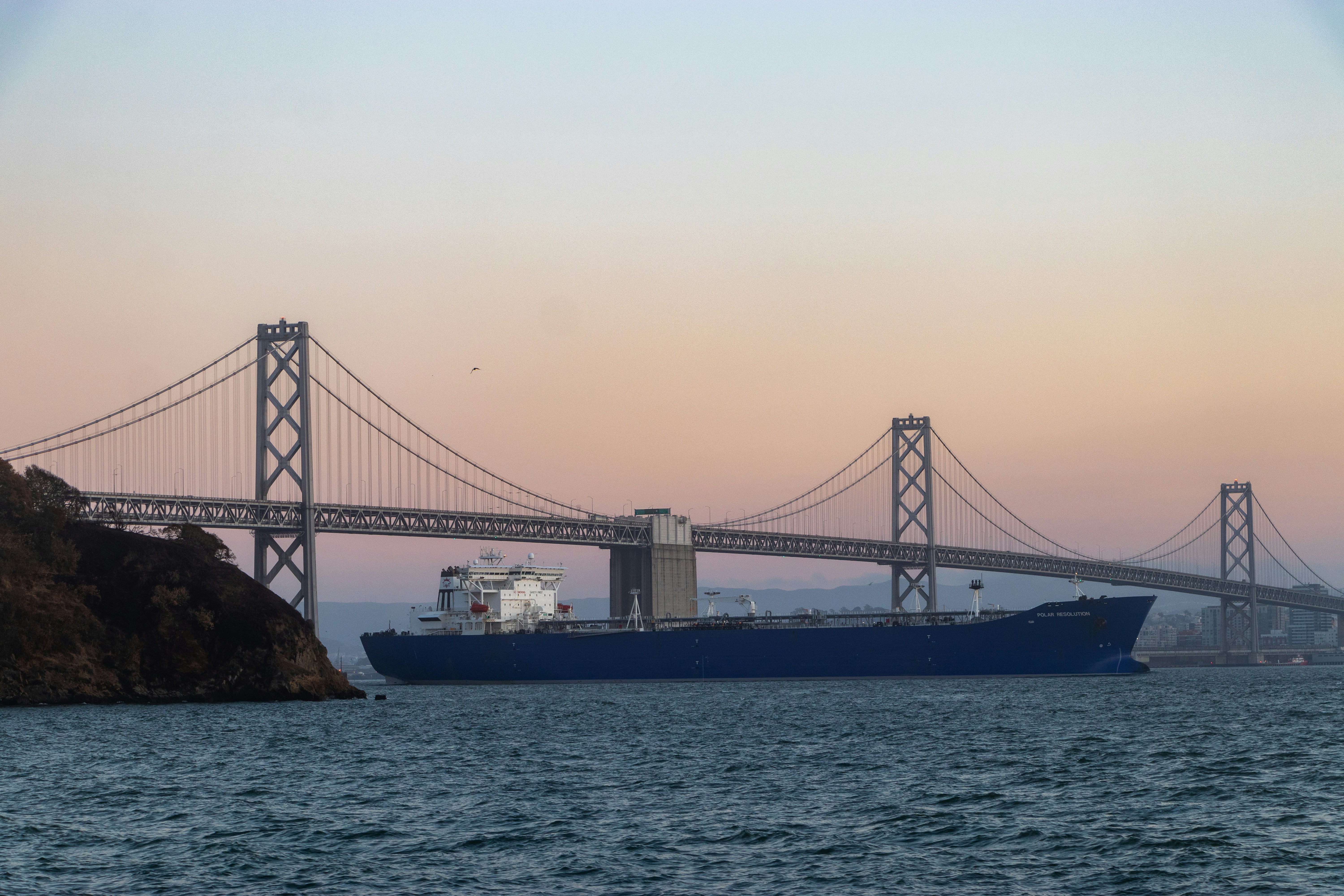 Black bridge over the sea during daytime