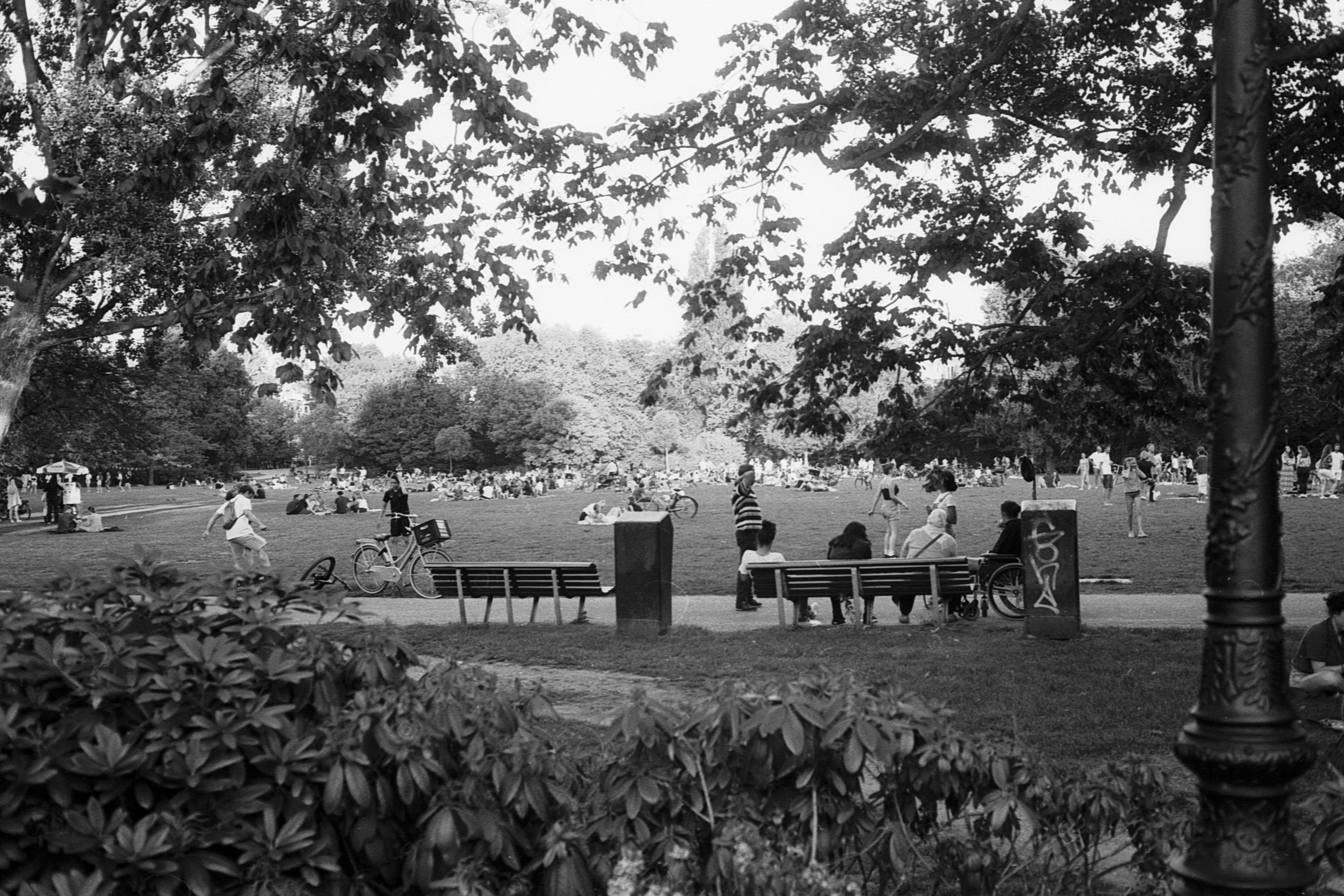 grayscale photo of people sitting on bench