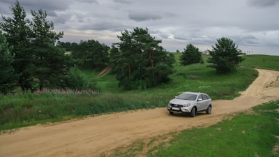Spacious grey SUV cruising along a scenic country road.