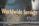 Golden text displaying 'Worldwide Services' is set against a dark, reflective surface, likely part of a vehicle or metallic structure, featuring rivets and a slightly worn texture.