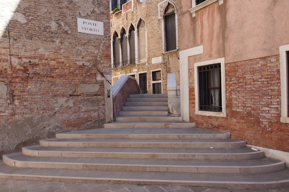 brown concrete staircase near brown brick building