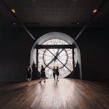 people walking on brown wooden floor