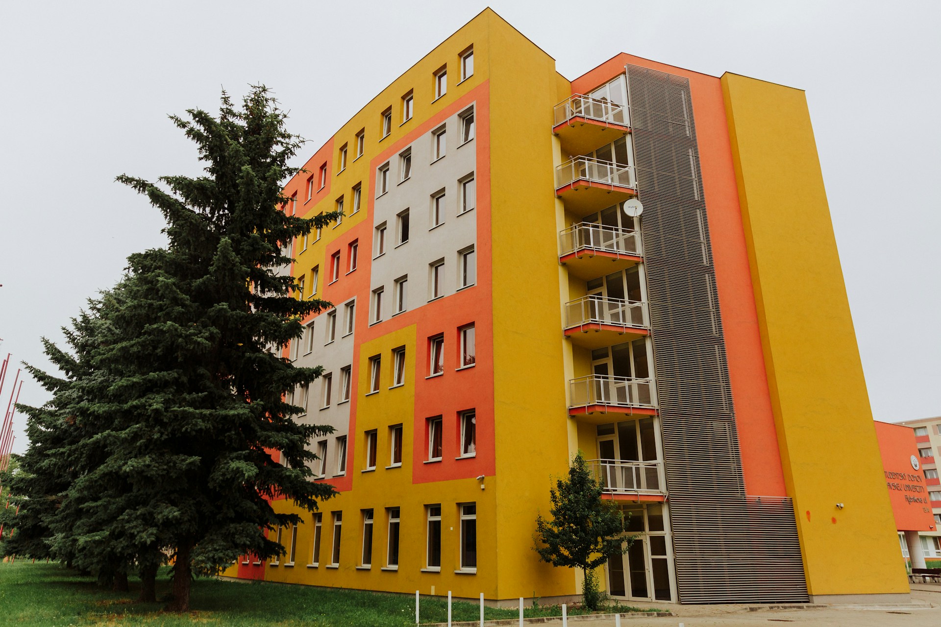 orange concrete building near green trees during daytime