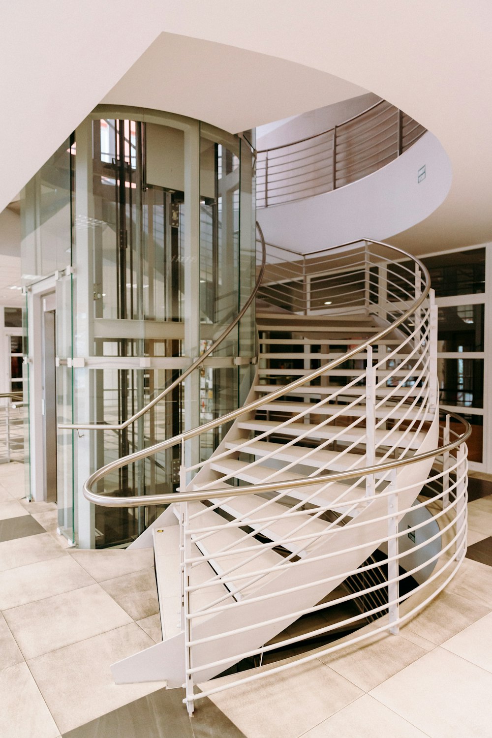 white spiral staircase with stainless steel railings