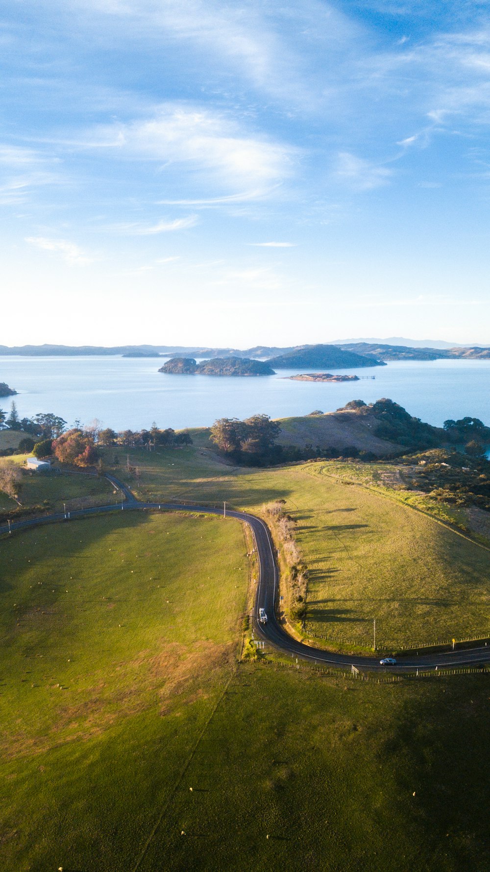 green grass field near body of water during daytime