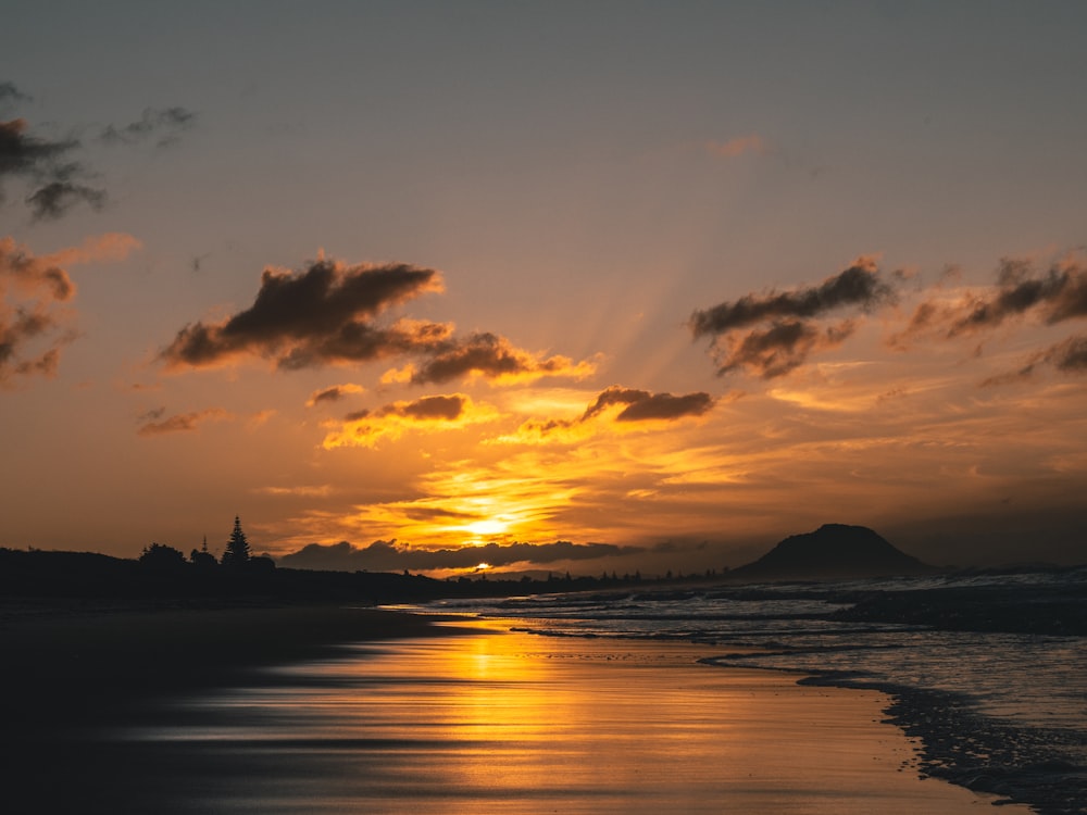 silhouette of island during sunset