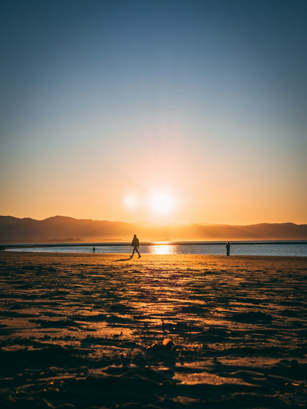 person standing on beach during sunset