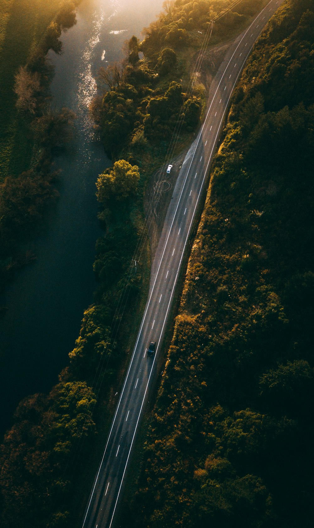 an aerial view of a road and a river