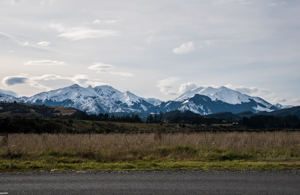 snow covered mountains under cloudy sky during daytime