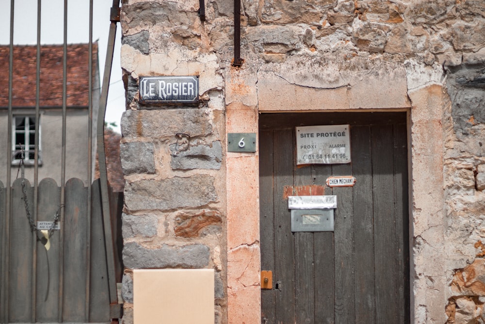 black and white wooden signage mounted on brown brick wall