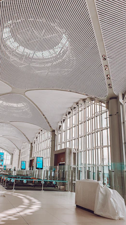 Interior view of a clean, modern electrolinera lounge with digital information panels.