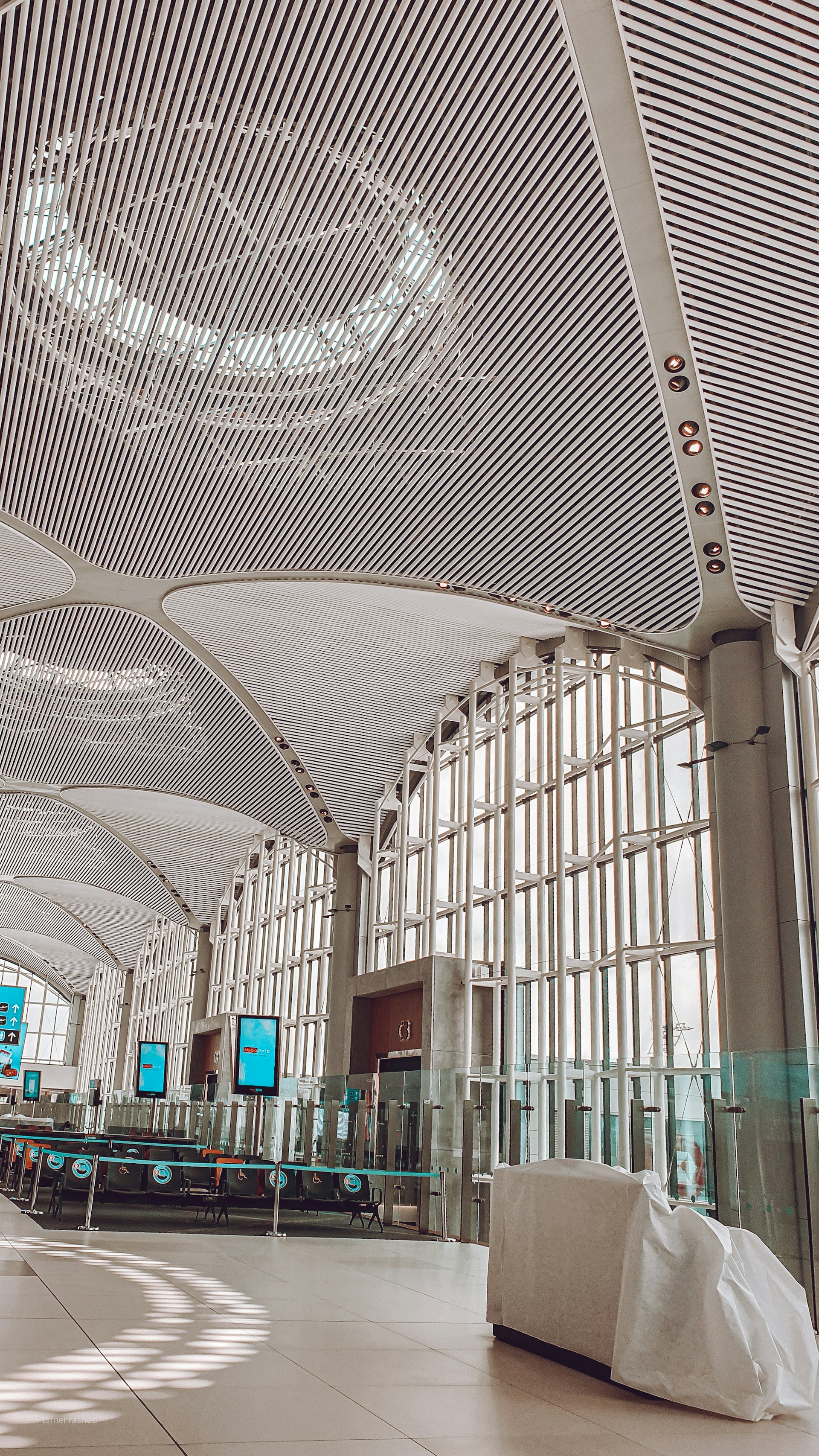 A wide-angle shot capturing the sleek, industrial-chic interior of the Samsung Conference Centre's main hall, bathed in natural light and showcasing its spacious layout.