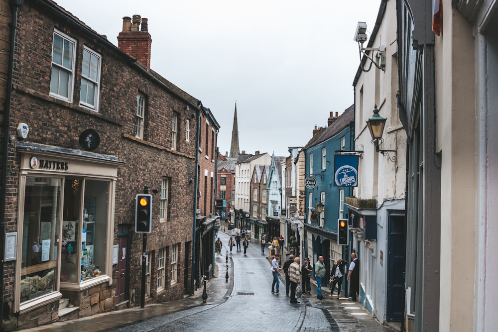 people walking on street between buildings during daytime