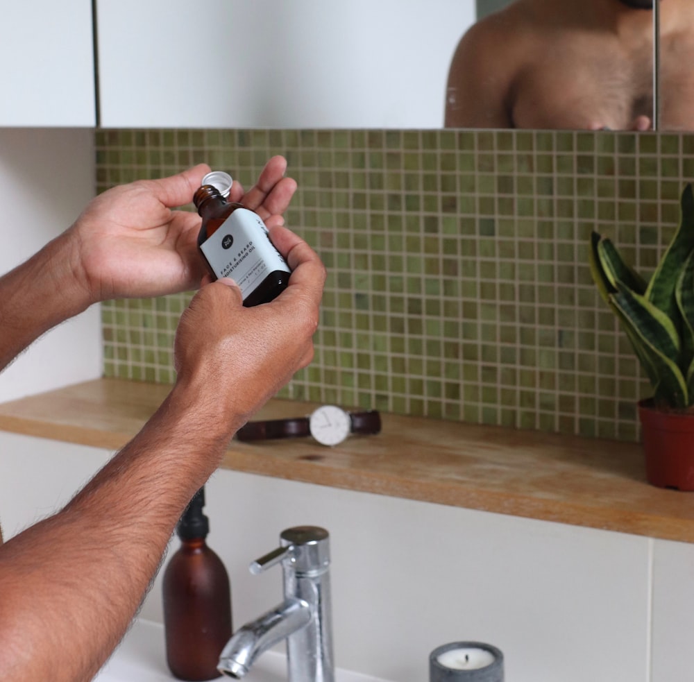 person holding silver and black device