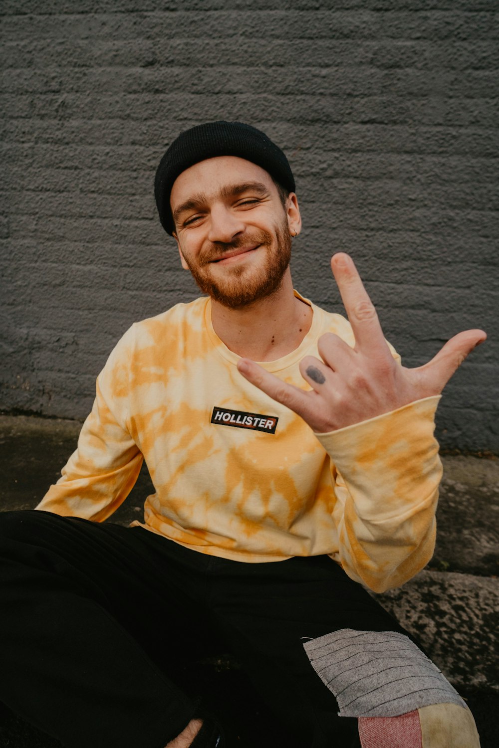 man in yellow crew neck shirt and black knit cap