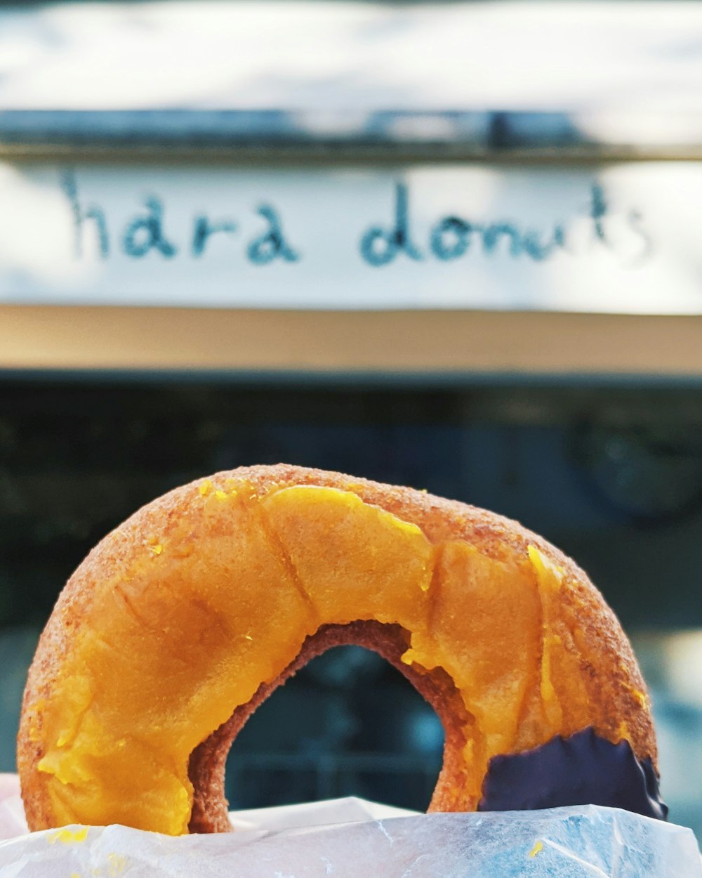 brown doughnut on white and brown wooden table