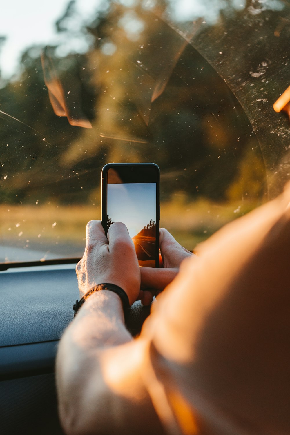 person holding black iphone 4