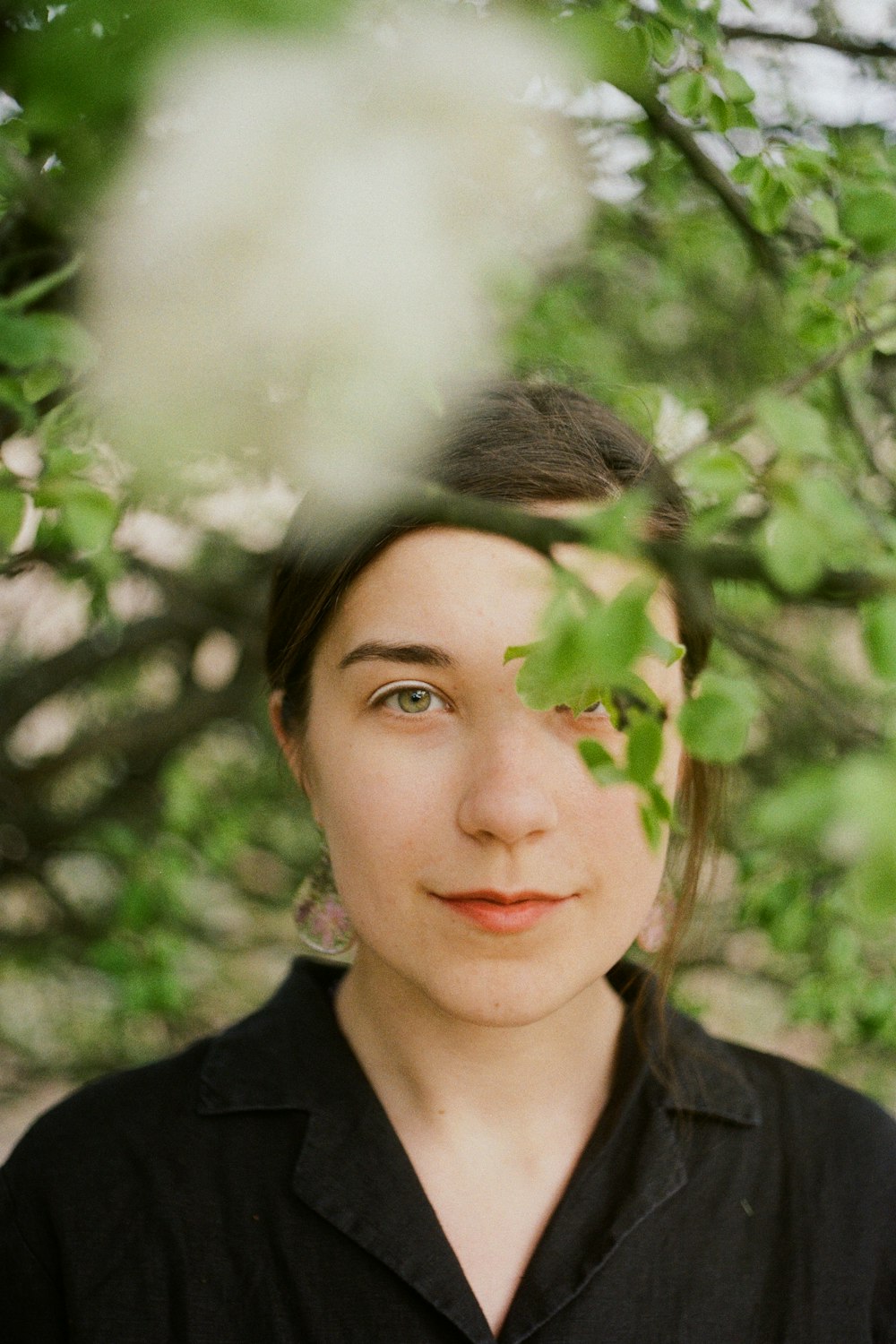 woman in black shirt with green leaves on her head