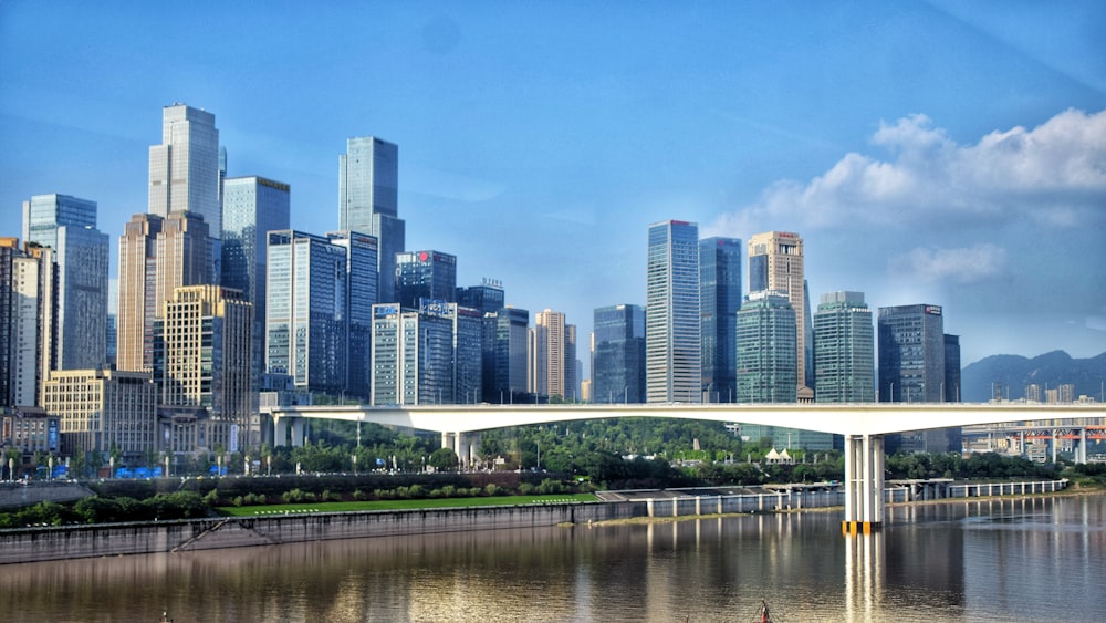 white bridge over river near city buildings during daytime