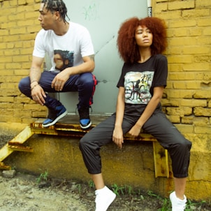 man and woman sitting on brown wooden bench