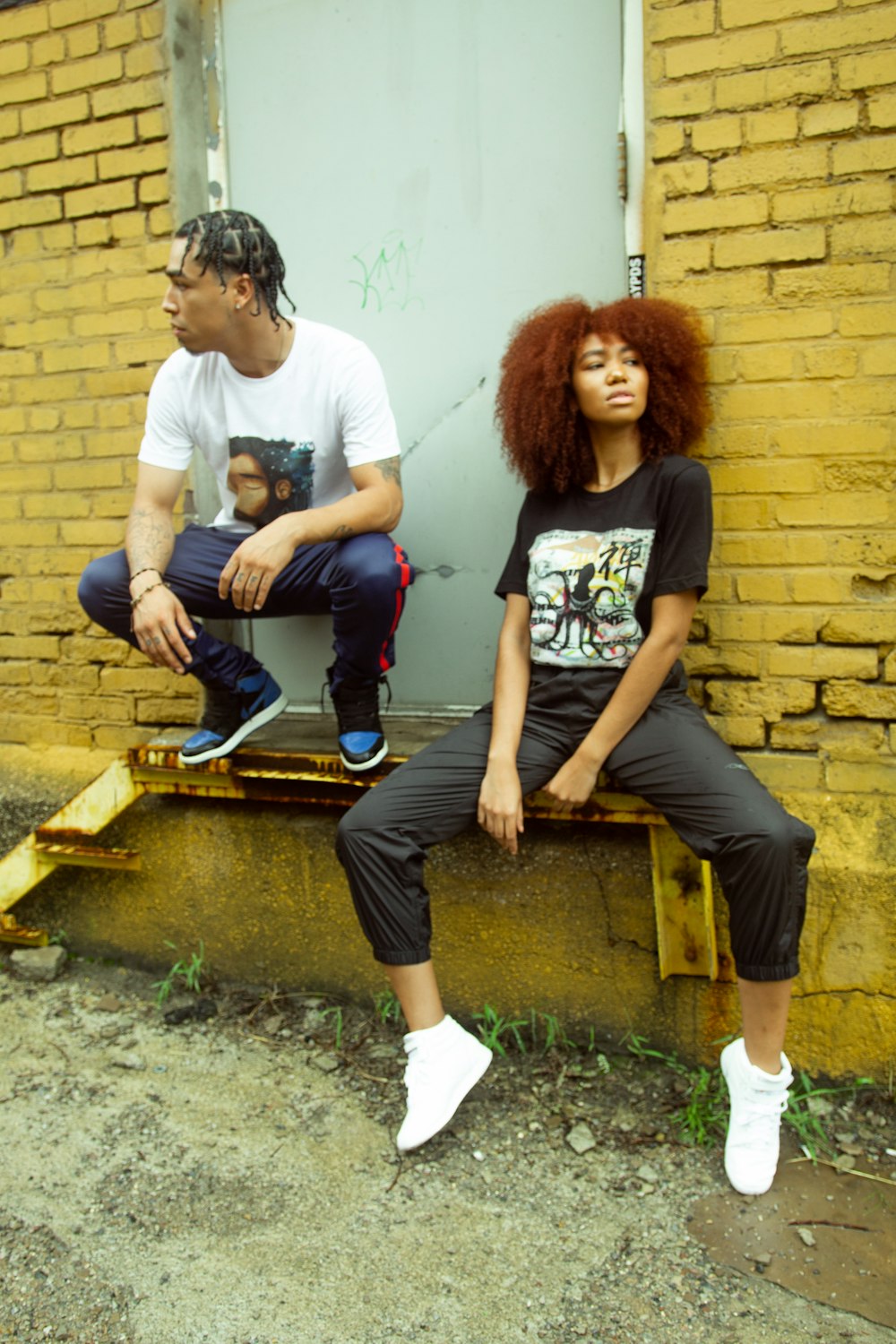 man and woman sitting on brown wooden bench