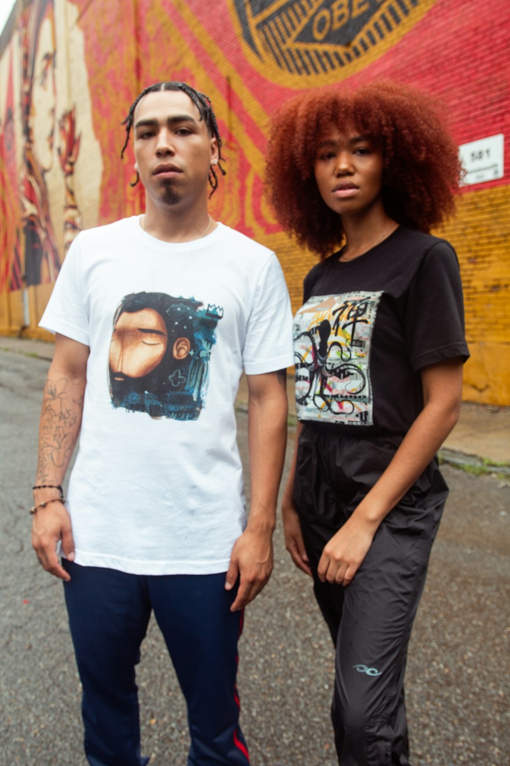 man in black crew neck t-shirt standing beside woman in white crew neck t-shirt