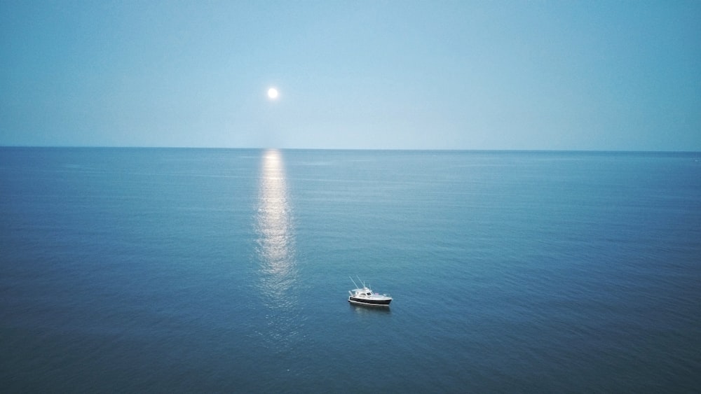 white boat on blue sea during daytime