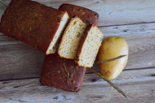 Sliced bread on brown wooden chopping board
