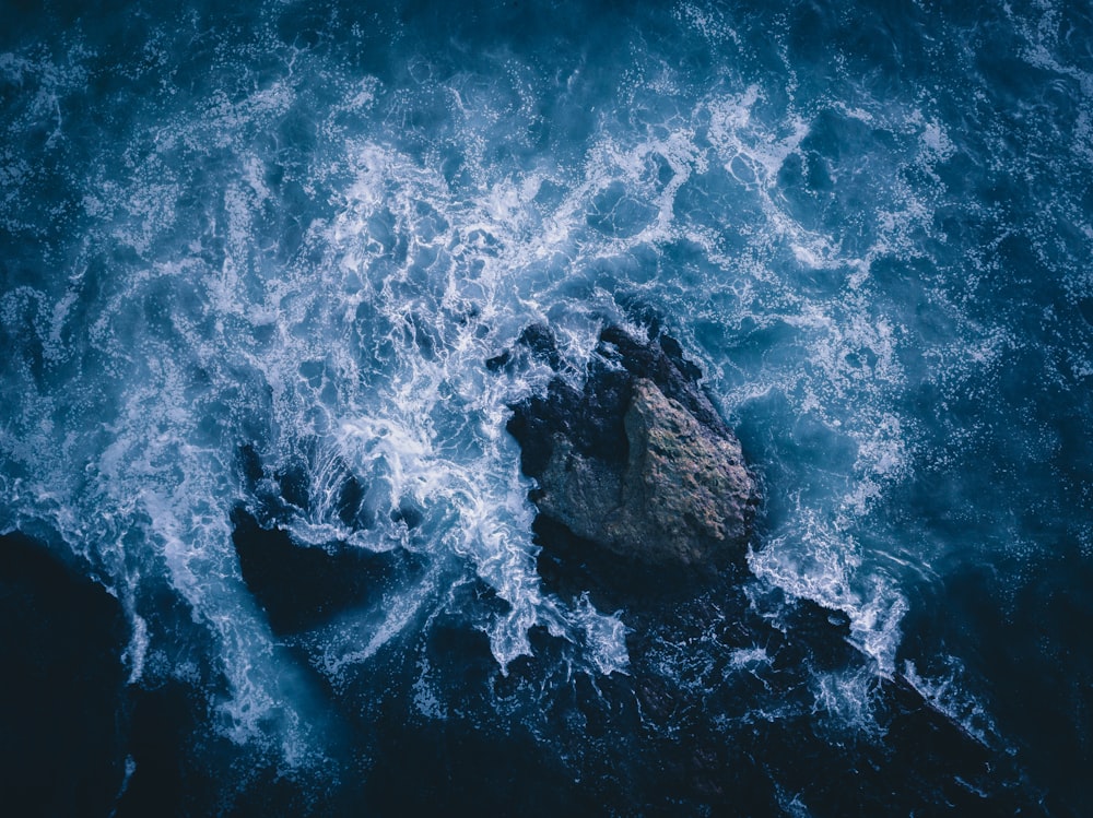 water waves on blue ocean water during daytime
