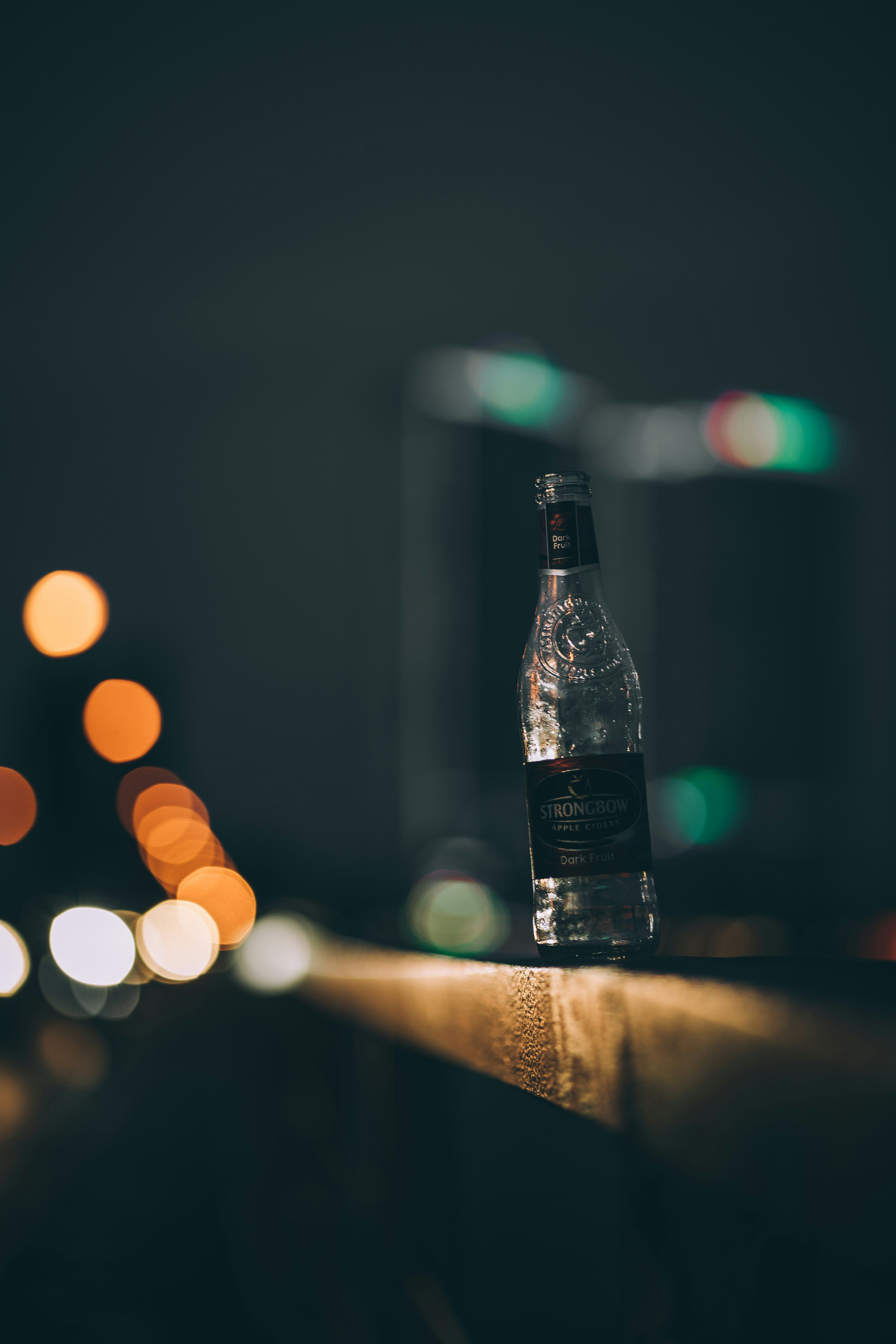 black labeled bottle on brown wooden table