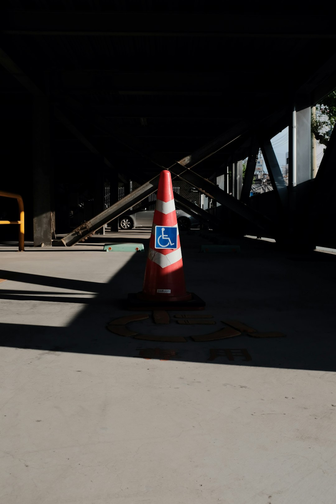 red and white traffic cone on gray concrete floor