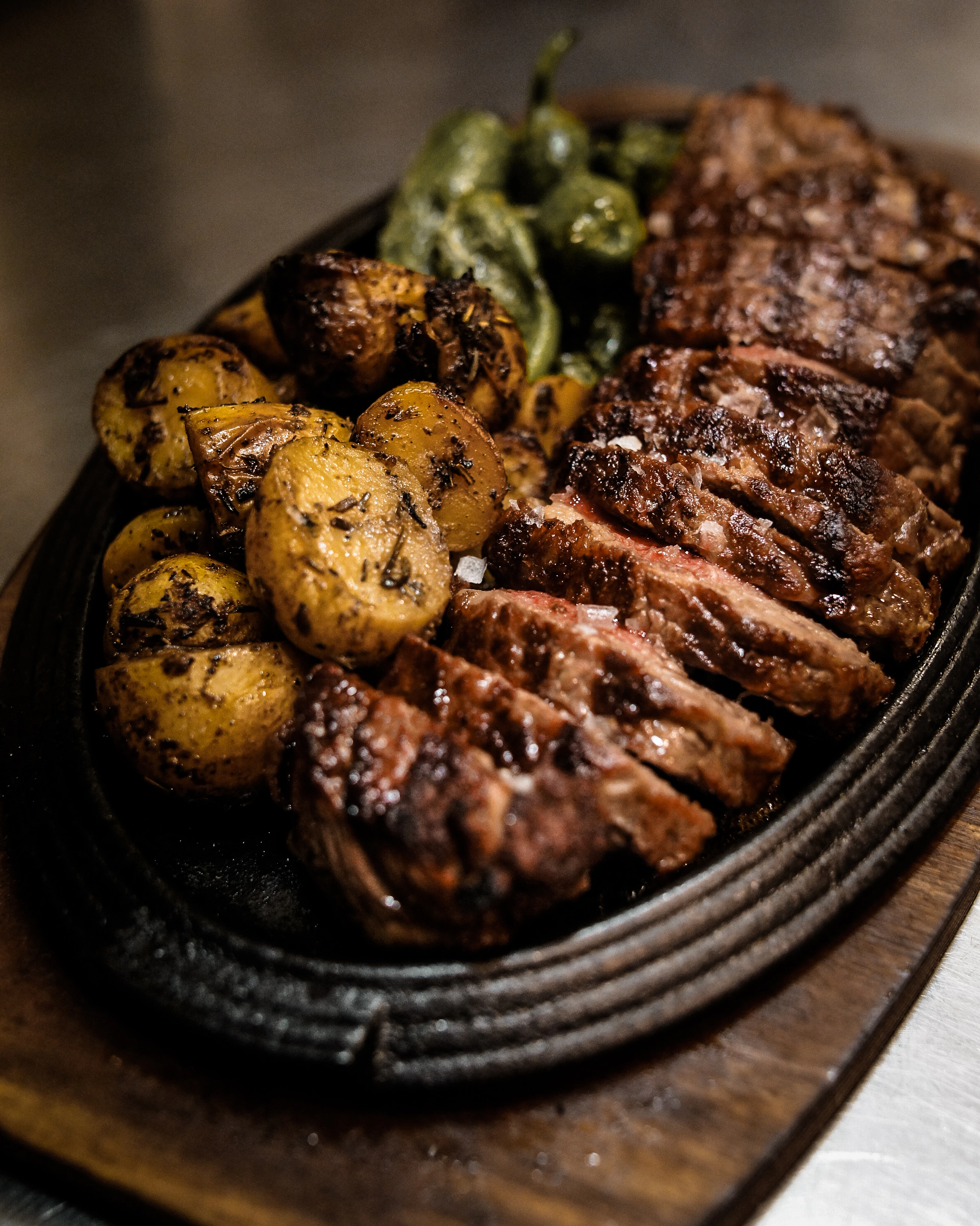 Grilled meat and potatoes in a skillet
