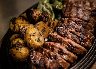 grilled meat on black ceramic plate