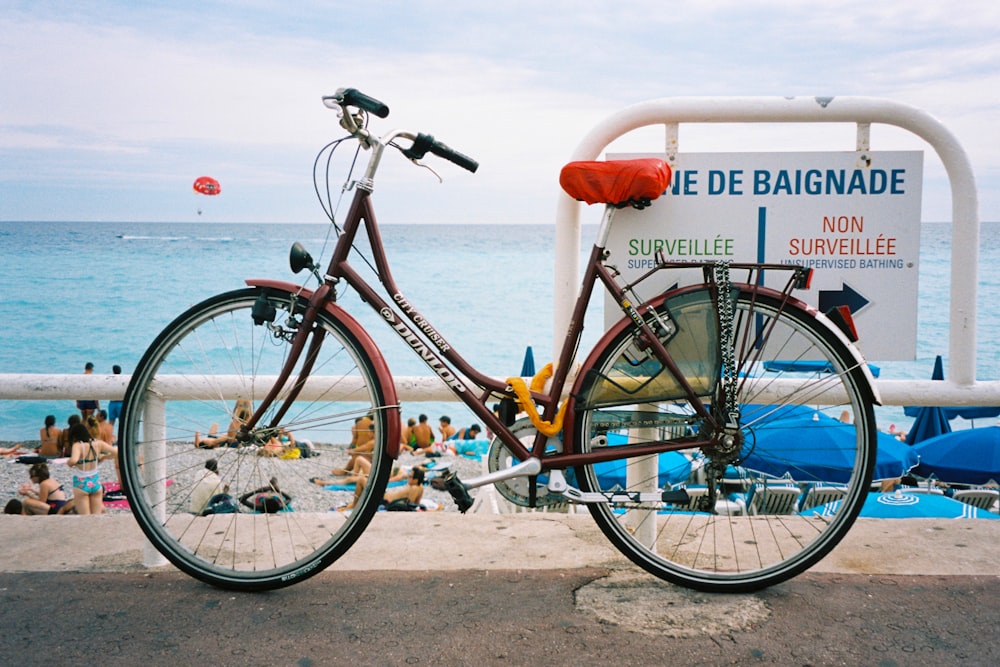 blue and black commuter bike on beach during daytime