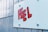 A close-up of a textured wall featuring a stylized word 'FEEL' painted or pasted in bold red letters with a black outline on a light blue background.