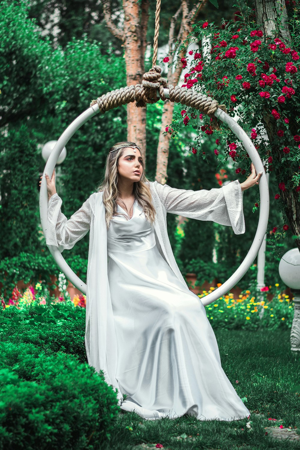 woman in white long sleeve dress standing on green grass field