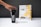 A hand reaches for a black shaker cup with the brand name 'CTRL' printed in white. Next to it, a package labeled 'Cinnamon Toast' displays images of cereal pieces with a splash of milk. The background is neutral gray.