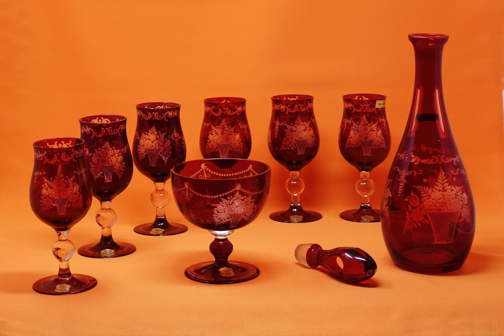 3 red wine glasses on white table