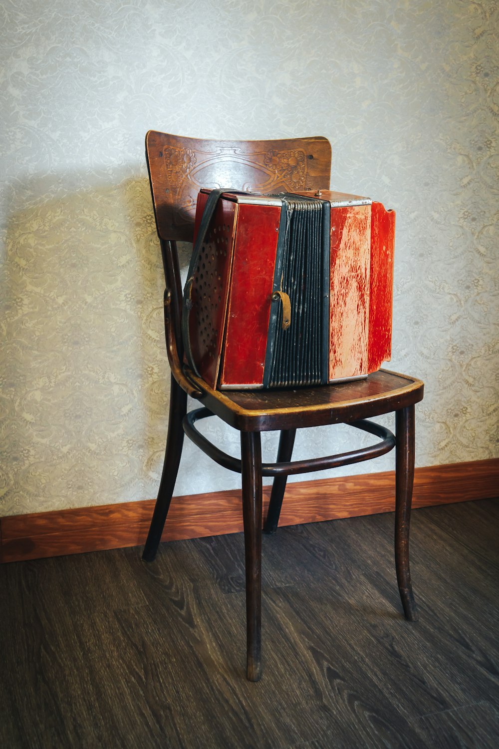 red and black hardbound book on brown wooden chair