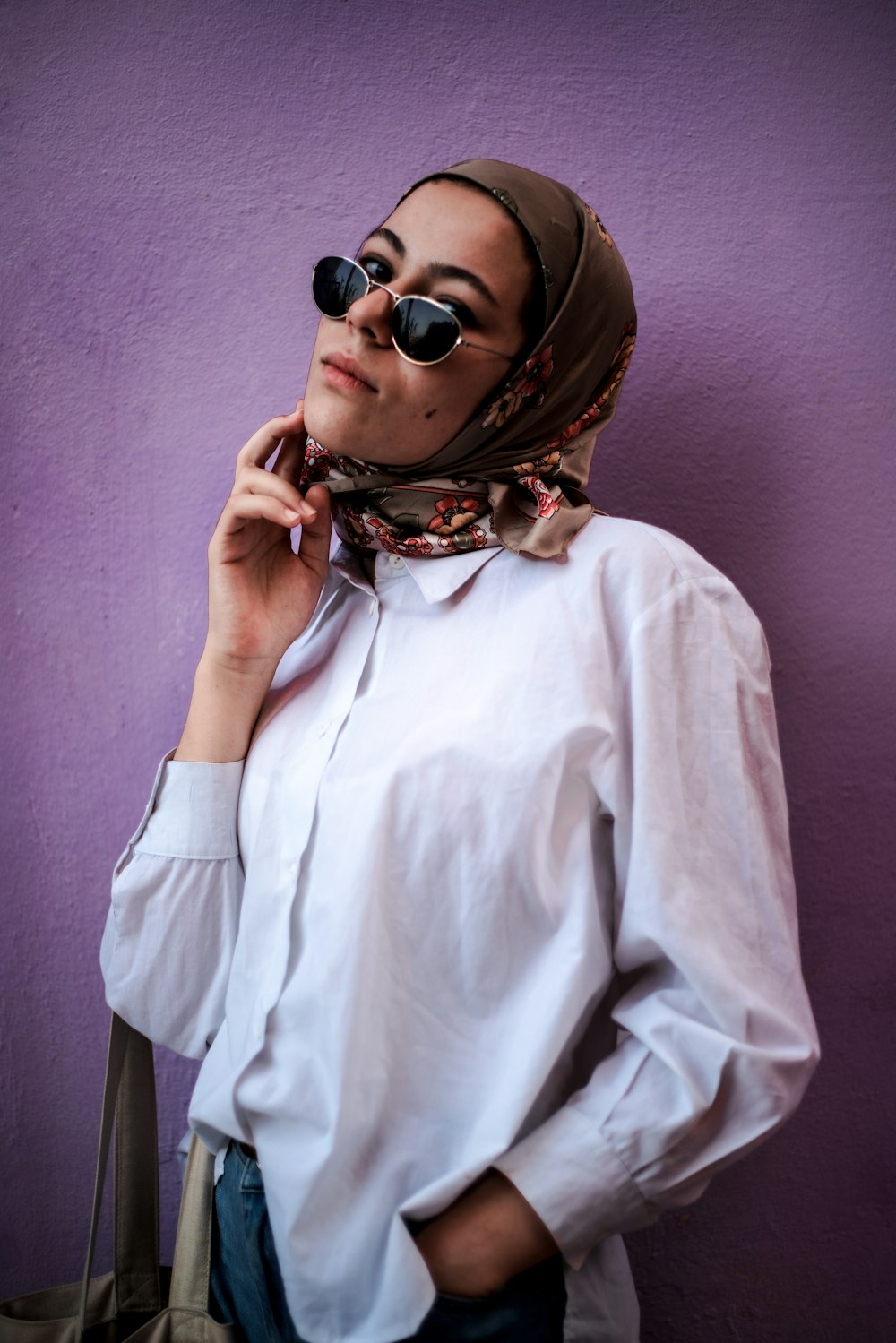 woman in white dress shirt wearing brown sunglasses