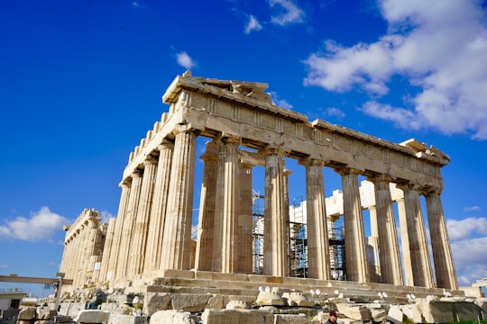 beige concrete building under blue sky during daytime in Parthenon Greece