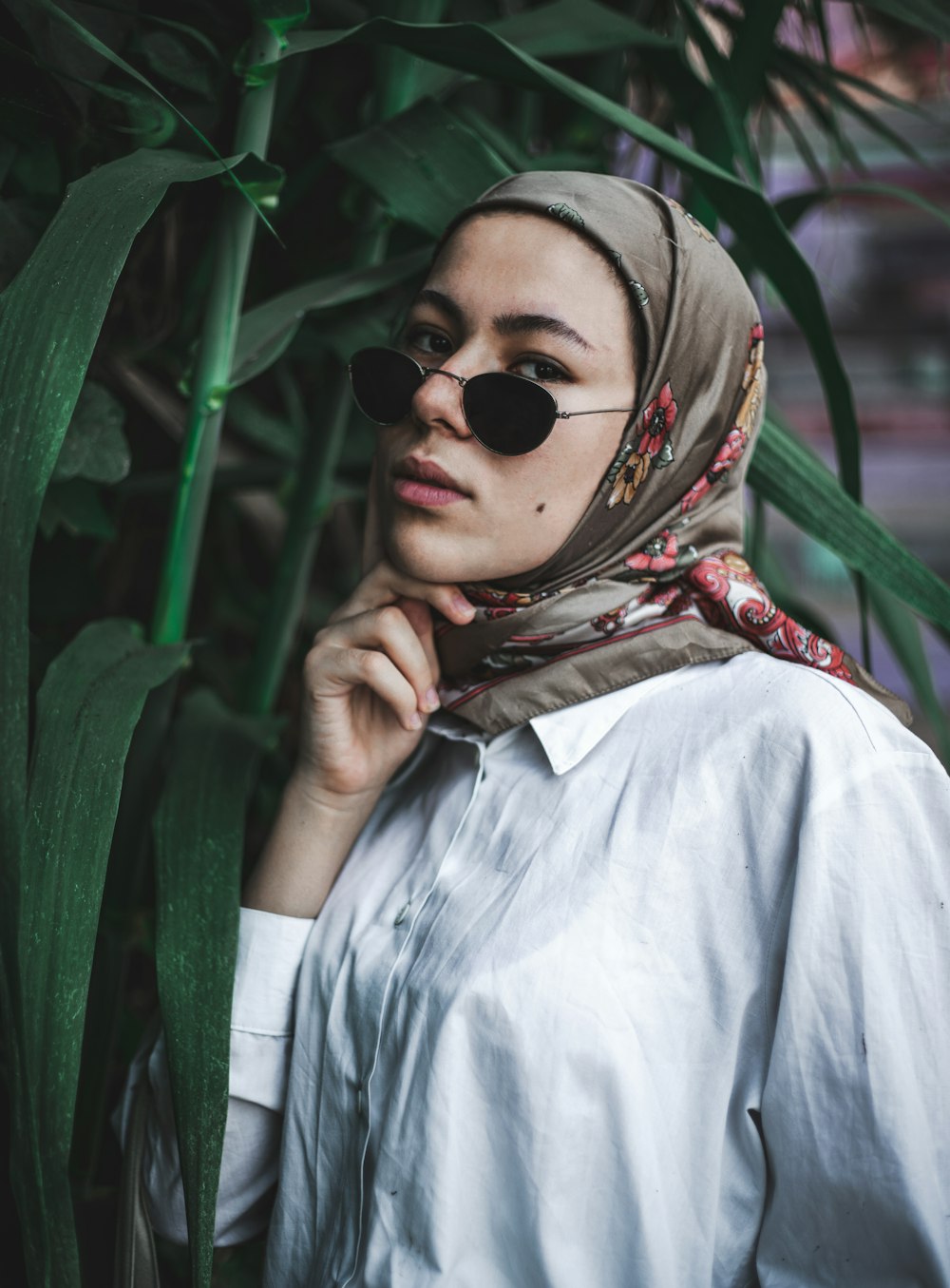 woman in blue dress shirt wearing sunglasses