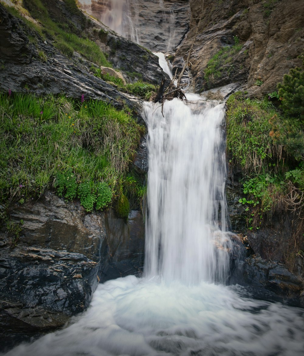 waterfalls on rocky mountain during daytime