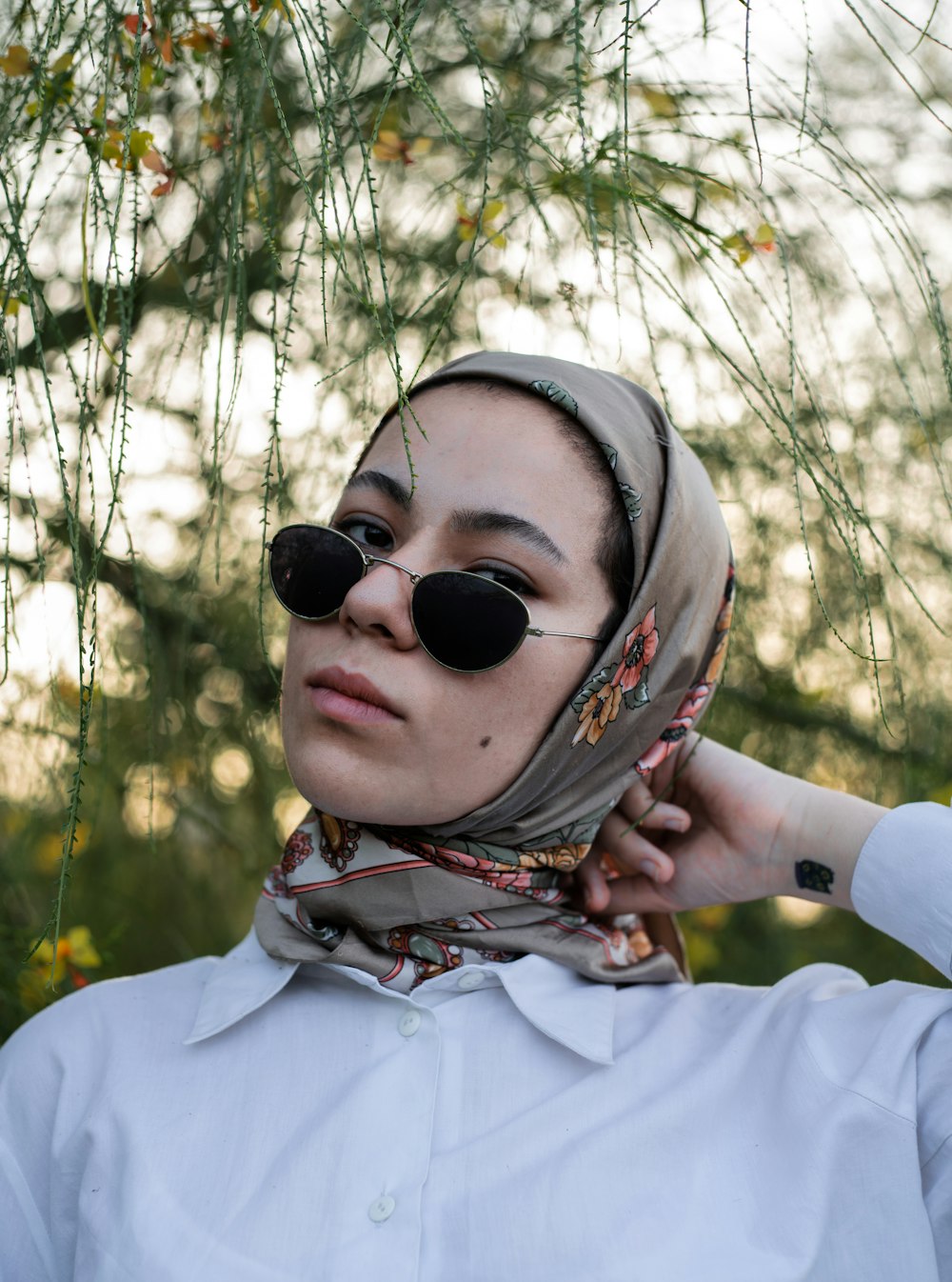 woman in white long sleeve shirt wearing black sunglasses