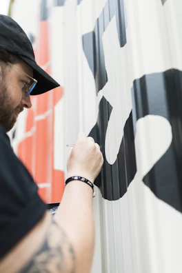 A detailed shot of vinyl lettering being carefully applied to a glass window.