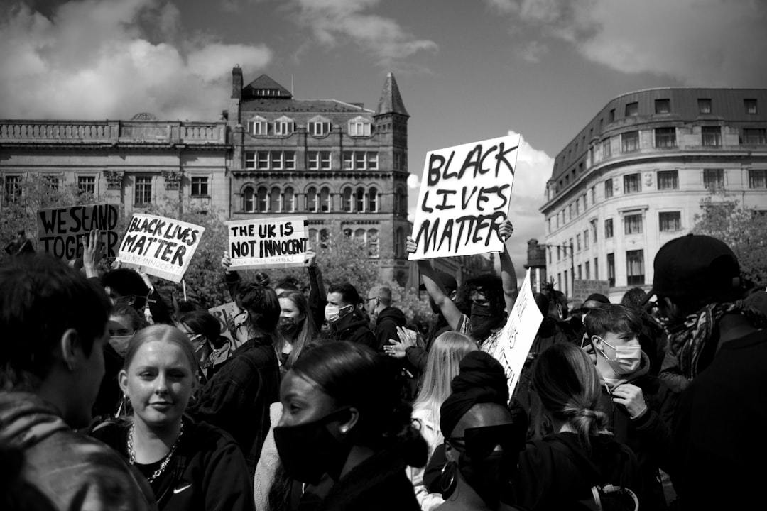 grayscale photo of people gathering near building, The people of Manchester break lockdown to join the global Black Live