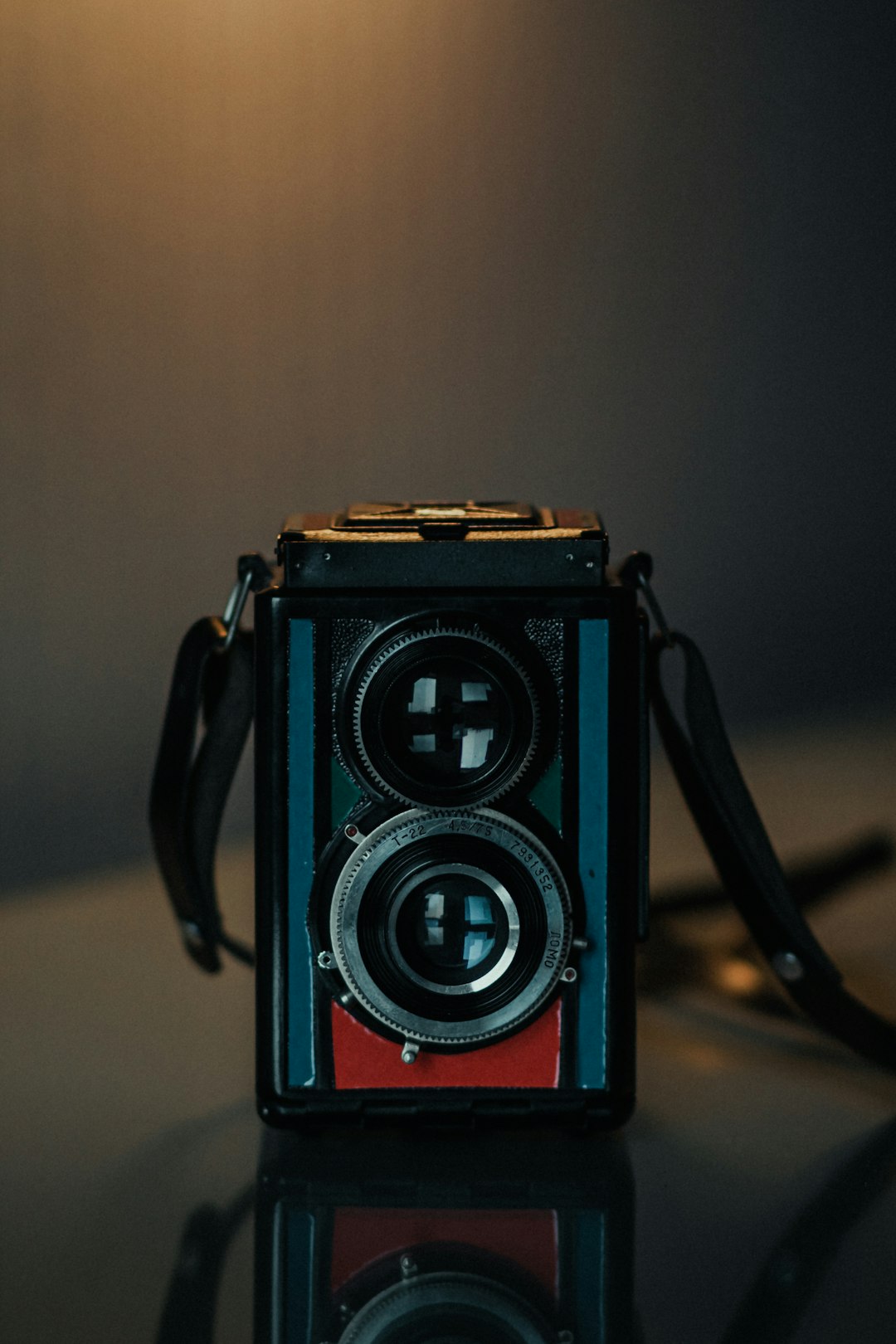 black and red camera on brown table