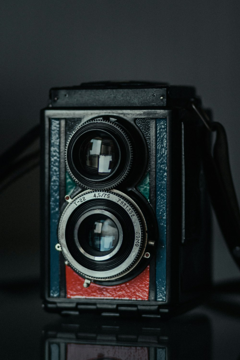 black and red camera on white table