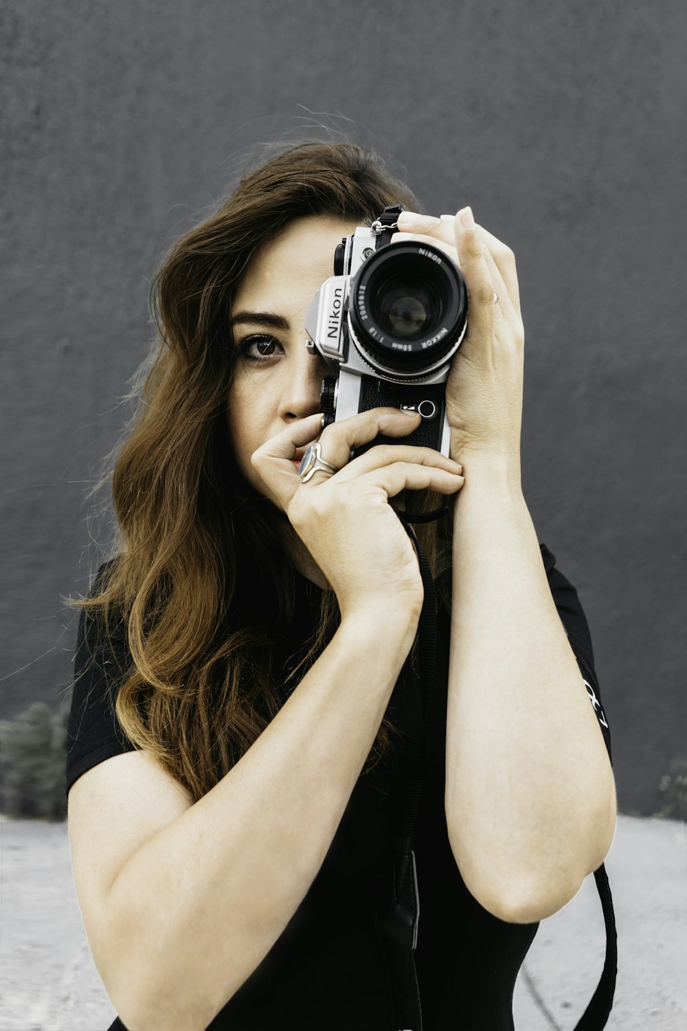 woman holding black and silver camera
